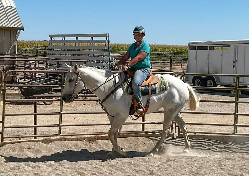 Sarah riding gray mare in round pen